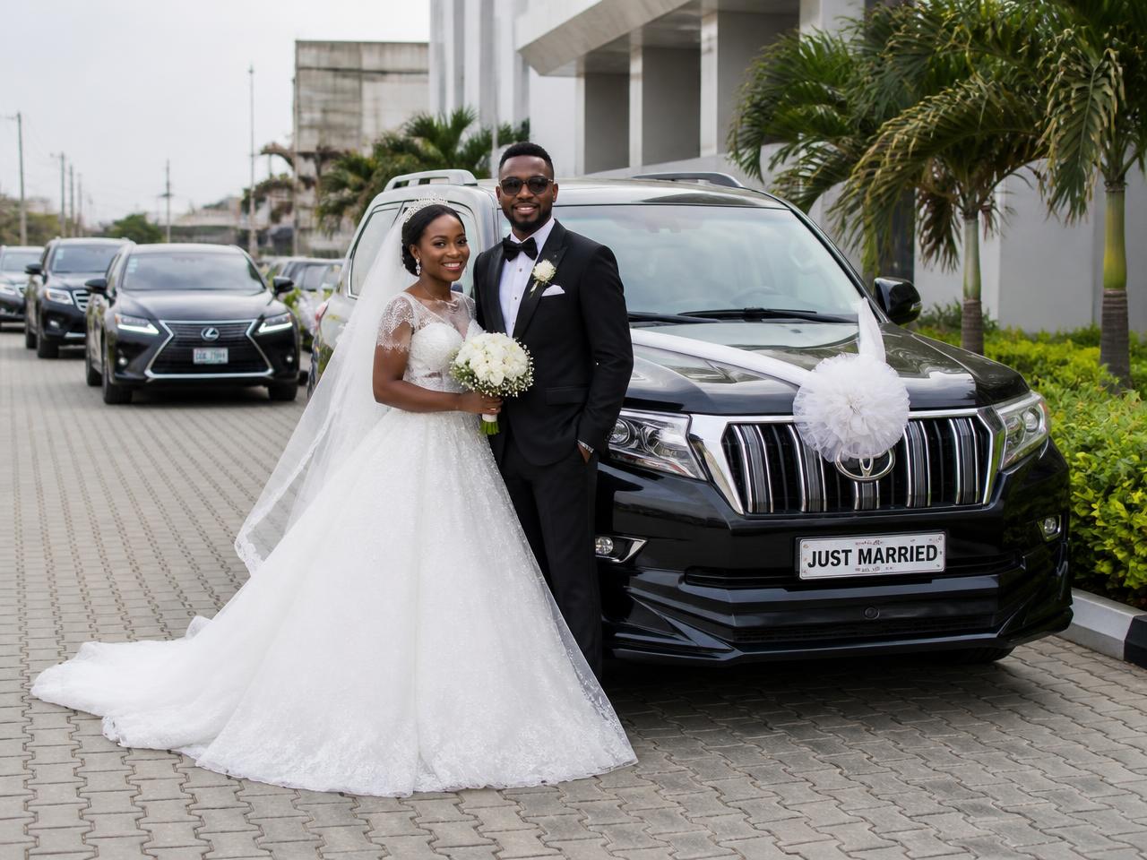 Nigerian bride and groom beside a decorated black Toyota Prado with a Lexus wedding convoy in Lagos